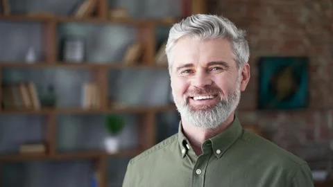 Close-up portrait of bearded man with gray hair smiling happily standing  Stock Footage 328706474