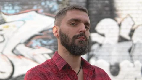 Close up portrait of bearded man posing confidently and looking haughtily Stock Photos