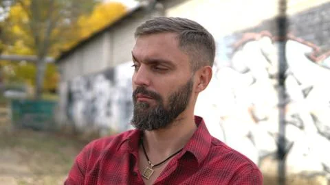 Close up portrait of bearded man posing confidently and looking at appraising 스톡 사진