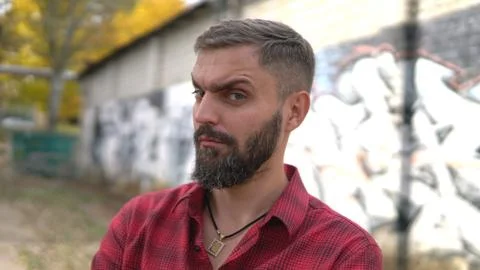 Close up portrait of bearded man posing confidently and looking at inquiringl 写真素材