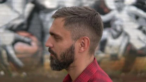 Close up portrait of bearded man posing confidently and looking at appraising Stock Photos