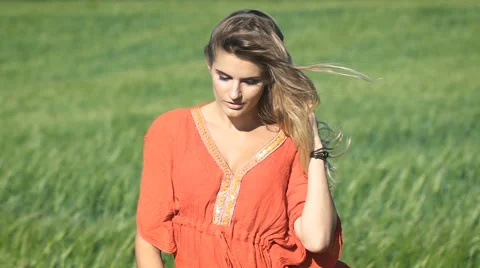 Close-up portrait of a beautiful blonde young romantic woman in a red shirt Stock Footage
