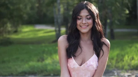 Close-up portrait of a beautiful girl in evening dress. Young woman looking into Stock Footage