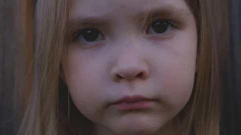 Close-up portrait of a beautiful little girl posing outdoors Stock Footage