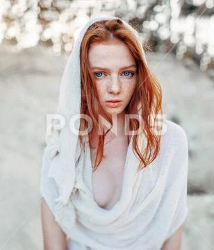 Close up portrait of a beautiful red haired girl in white medieval dress on Stock Photos