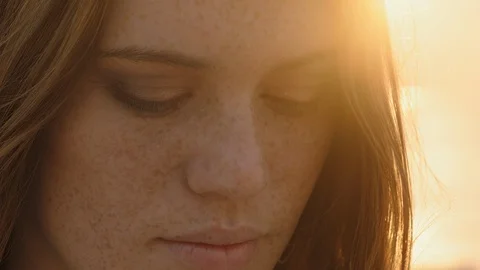 Close up portrait beautiful red head woman opening eyes meditating at sunset Stock Footage 99795549