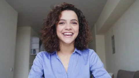 Close-up portrait of beautiful smiling young woman looking at camera at home. Stock Footage 143229456
