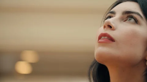 Close up portrait of beautiful young brunnete girl with green eyes looking up Video stock 115716614