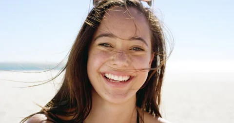 Close up portrait of beautiful young woman smiling on tropical beach slow motion Stock Footage