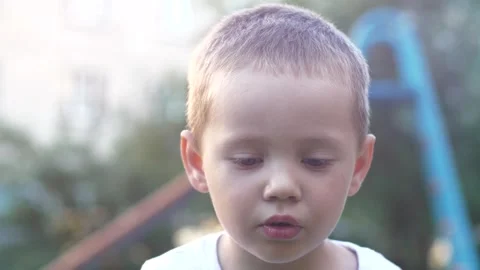Close-up portrait of a boy blowing soap bubbles Stock Footage 277851553