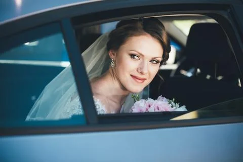 Close-up portrait of a bride in car window Stock Photos