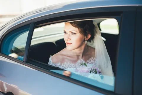 Close-up portrait of a bride in car window Stock Photos