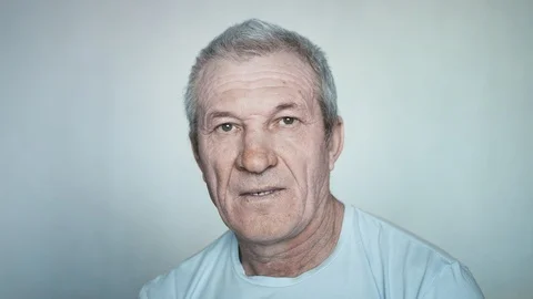 Close-up portrait of a brooding elderly man looking at the camera Stock Footage 113141155