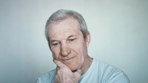 Close-up portrait of a brooding elderly man looking into the camera Stock Footage 113141419