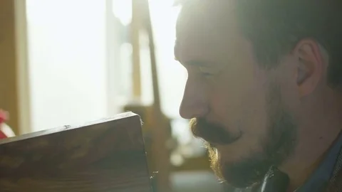 Close up portrait of carpenter checking quality of work wooden plank in Stock Footage 76104698