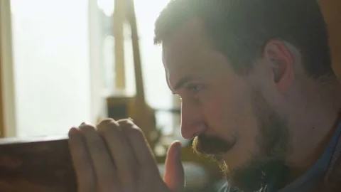 Close up portrait of carpenter checking quality of work wooden plank in Stock Footage 76105010