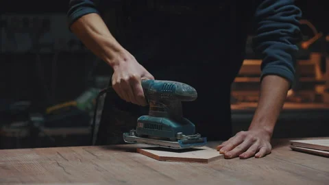 Close portrait of a carpenter with a grinder in his hands. A young apprentice Video stock 170667161