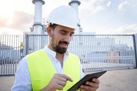 Close up portrait of a caucasian engineer using digital tablet to do an Stock Photos