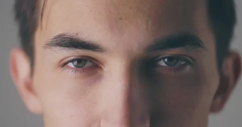 Close up portrait of caucasian male's eyes opening before smiling to camera, in Stock Footage