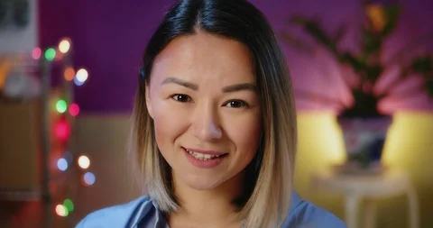 Close up portrait of charming beautiful young Asian woman smiling looking to Stock Footage 123673103