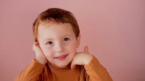 Close-up portrait of a charming cheerful red-haired boy Stock Footage 127701702