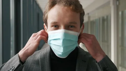 Close up portrait of charming man takes off the antivirus mask. Face of Stock Footage 146019673