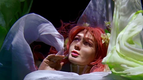 Close-up portrait of a charming red-haired mermaid with beautiful white flowers Stock Footage 110762785