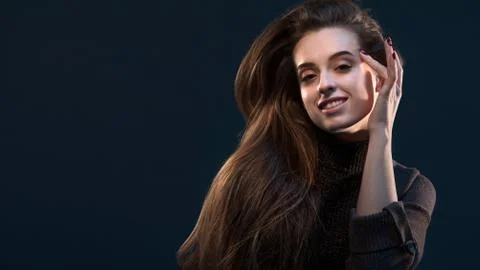 Close-up portrait of charming young thinking woman in black dress looking at  Stock Photos