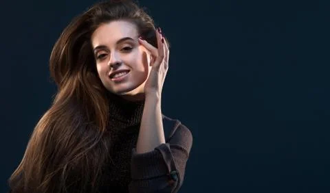 Close-up portrait of charming young thinking woman in black dress looking at  Stock Photos