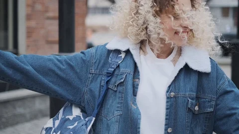 Close-up portrait of a cheerful beautiful and carefree girl walking around the Stock Footage 106900867