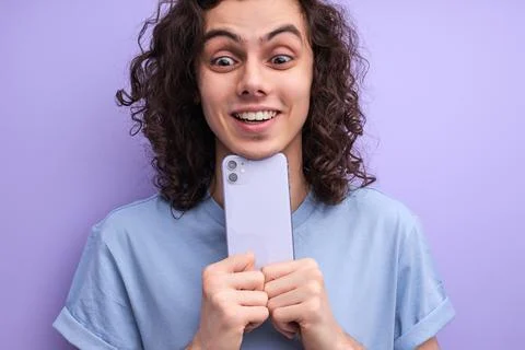 Close-up portrait of cheerful smiling guy taking photo on smartphone Stock Photos