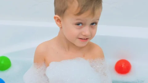 Close up portrait of a child having fun and looking at the camera in the tub Stock Footage 128841376