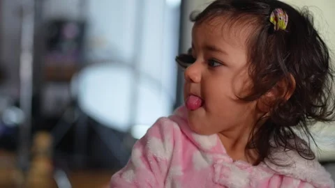 Close up portrait of child intensely focused on watching tv Stock Footage 303496383