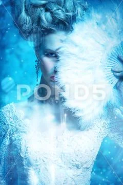 A close up portrait of a cold beautiful lady with a fan posing in the studio Stock Photos