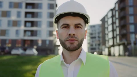 Close up portrait of confidence builder looking at camera standing outside near Stock Footage 242983361