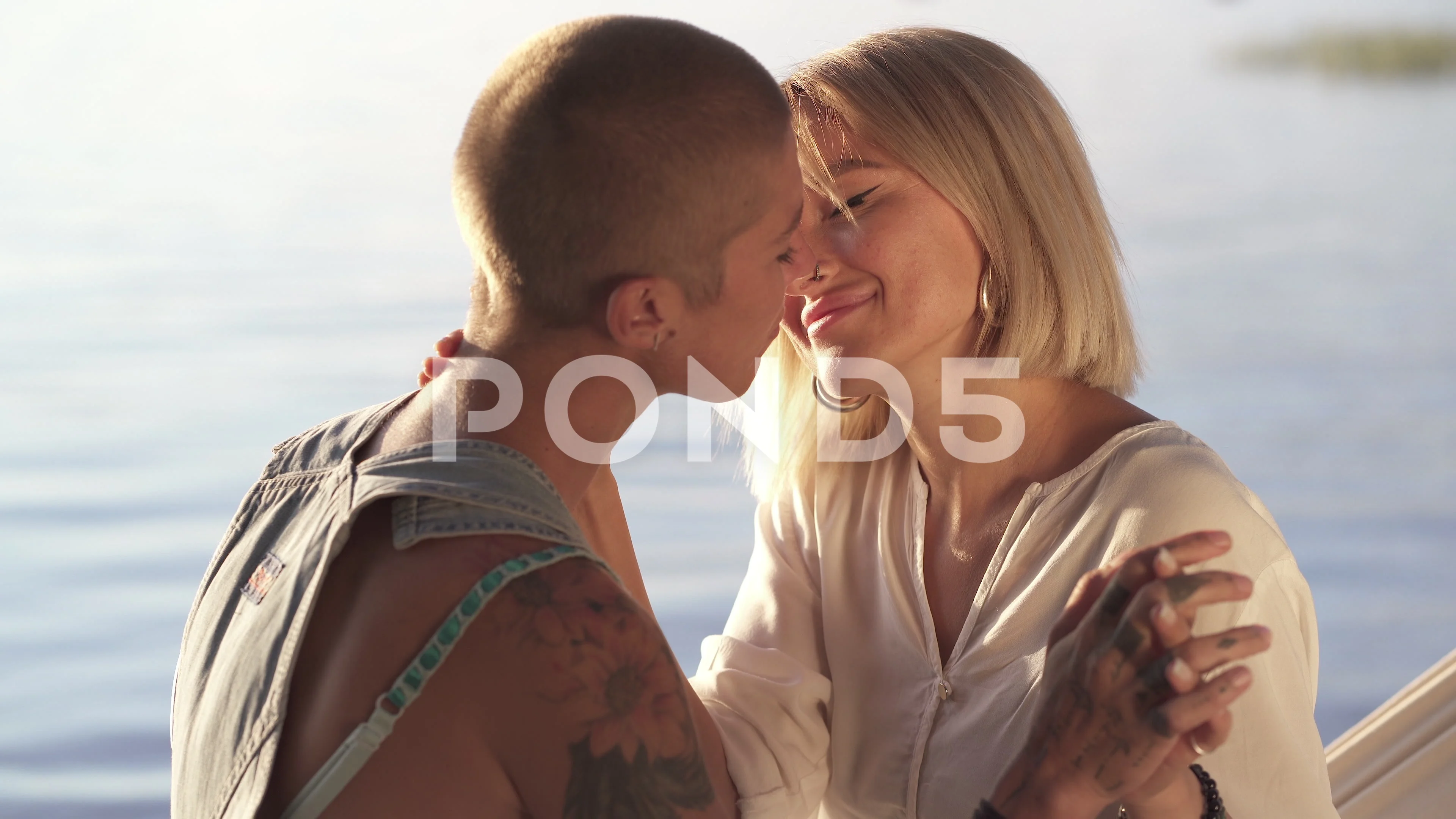 Close-up portrait of couple of woman hugging and flirting outdoors.