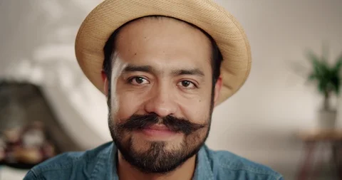 Close up portrait of creative handsome Hispanic man in hat smiling inside of Stock Footage 120743813