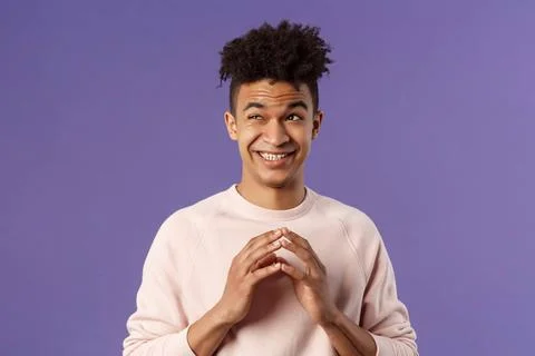 Close-up portrait of creative young hispanic guy steeple fingers while mak... Foto stock