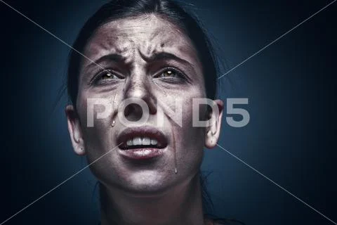 Close up portrait of a crying woman with bruised skin and black eyes ...