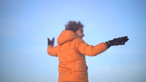 Close up portrait of curly-haired boy in winter against blue sky background Stock Footage 147941832