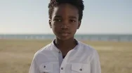 Close Up Portrait Of Cute African American Boy Looking Serious Pensive At Camera Stock Footage