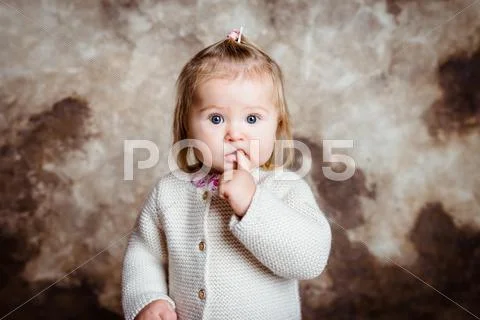 Close-up portrait of cute blond little girl with big grey eyes Stock Photos