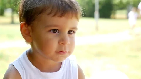 Close portrait of a cute little boy giving a kiss, slow motion Stock Footage
