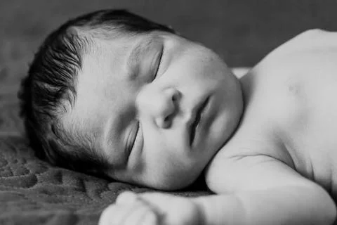 Close up portrait of a cute two weeks old newborn baby girl without clothes Stock Photos