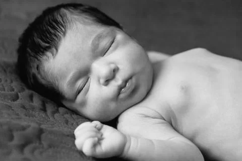Close up portrait of a cute two weeks old newborn baby girl without clothes Stock Photos