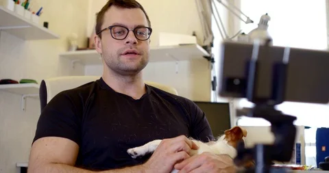 Close-up portrait of a dark-haired middle-aged man with glasses, sitting in a Vídeo Stock 129493661