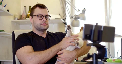 Close-up portrait of a dark-haired middle-aged man with glasses, sitting in a Vídeo Stock 129734621