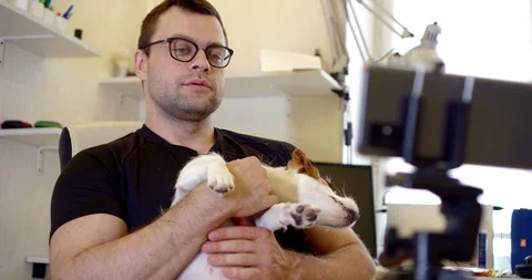 Close-up portrait of a dark-haired middle-aged man with glasses, sitting in a Vídeo Stock 129827014