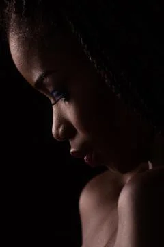 Close up portrait of dark skinned model on black backstage. Stock Photos