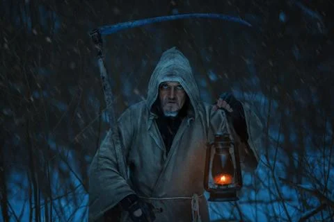 Close-up portrait of death with a scythe. Stock Photos
